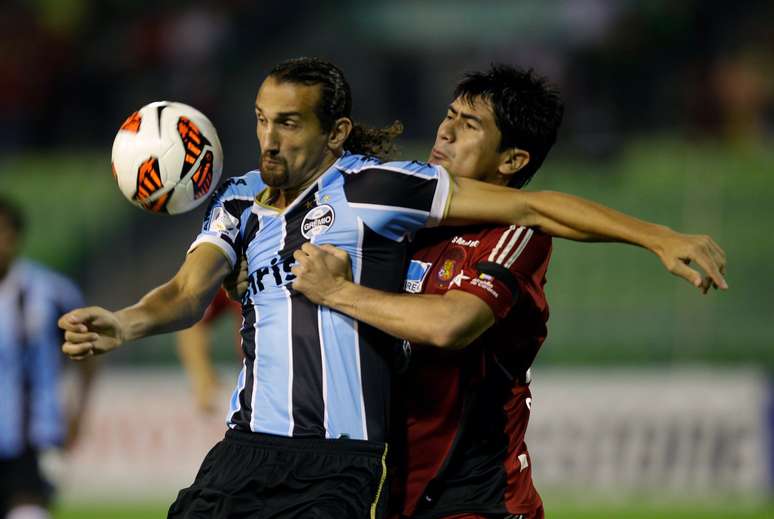 <p>Barcos protege bola da presença de Sanchez; Grêmio fez segundo tempo ruim e levou a virada do Caracas</p>