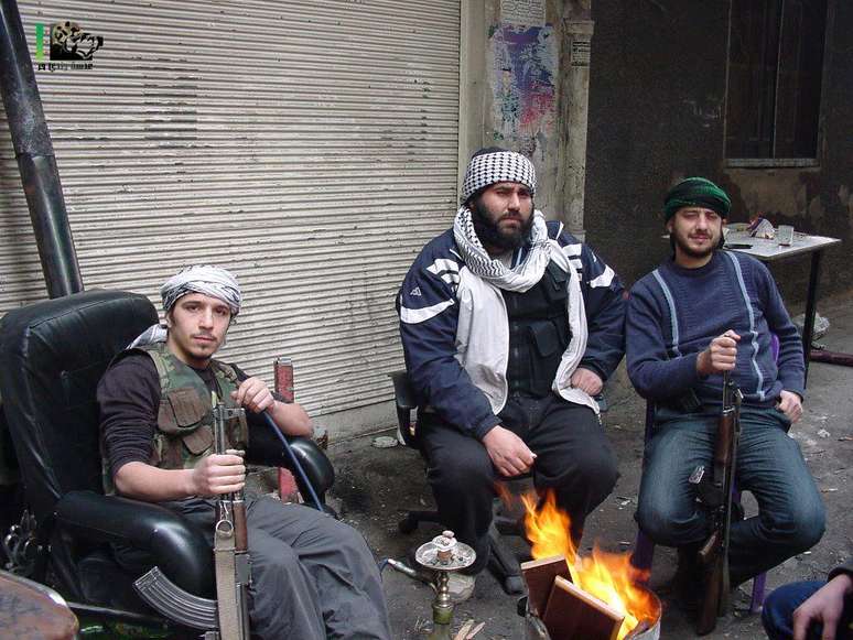 Barakat (primeiro à esquerda) e companheiros rebeldes em bairro de Damasco, fumando a tradicional narguile