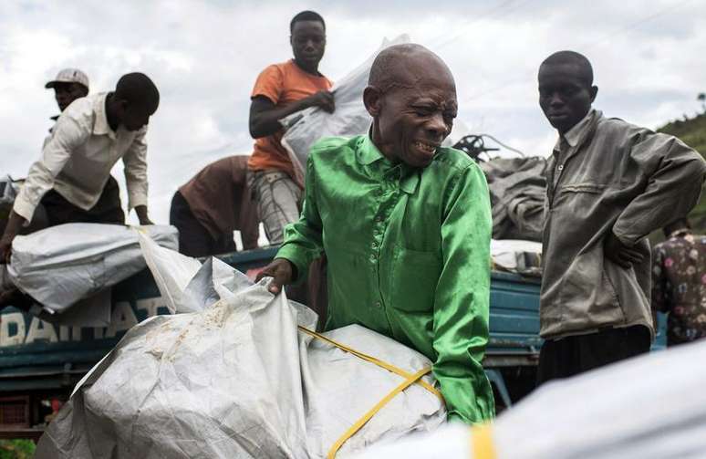 Refugiados descarregam lonas de veículo em Mubimbi, República Democrática do Congo. A África do Sul irá enviar tropas para a República Democrática do Congo, parte de uma missão das Nações Unidas para neutralizar os grupos armados em conflito no leste do país, afirmou um porta-voz militar sul-africano neste domingo. 04/03/2013