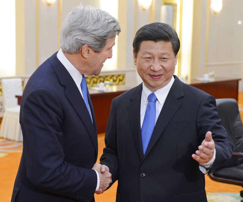 O presidente chinês, Xi Jinping (dir.), posa para foto com o secretário de Estado americano, John Kerry, em Pequim