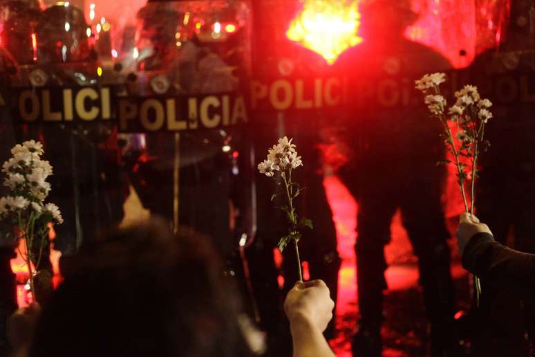 <p>Manifestantes mostram flores para Tropa de Choque durante confronto na &uacute;ltima ter&ccedil;a-feira</p>