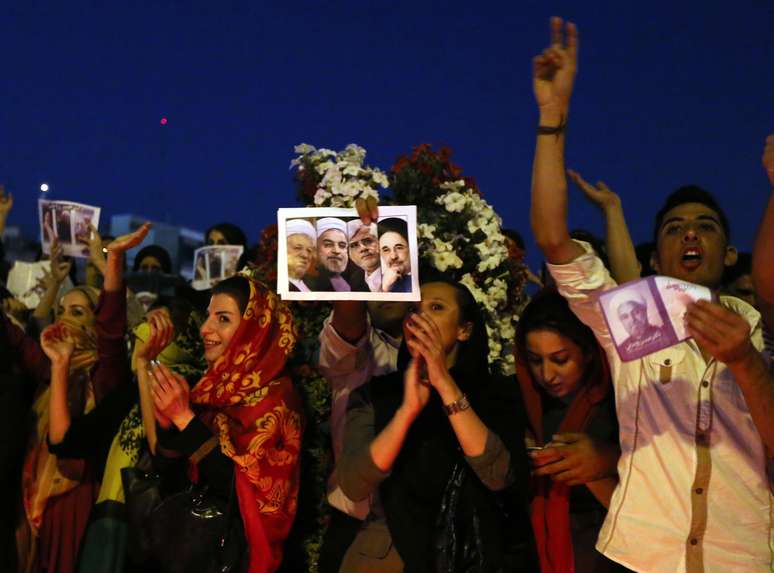 Eleitor segura o retrato de Rohani