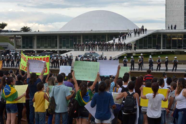 <p>Manifestantes mostram cartazes e gritam palavras de ordem ao Congresso Nacional, que estava vazio</p>