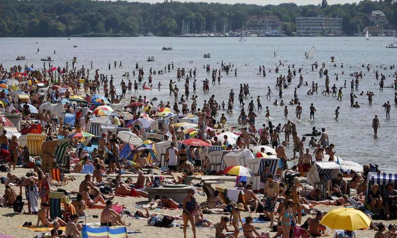 Pessoas tomam banho de sol em praia do lago Wannsee, em Berlim 