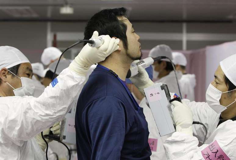 Funcionário é escaneado por radiação ao entrar no centro de operações de emergência da Tokyo Electric Power (Tepco) na usina nuclear de Fukushima, no Japão. 20/02/2012.