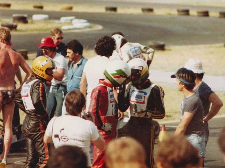 Terry Fullerton (macacão vermelho) conversa com Ayrton Senna (macacão preto) no Circuito de Jesolo, Itália, em 1979; Senna ainda corria com o capacete antigo, cinza com detalhes em verde e amarelo