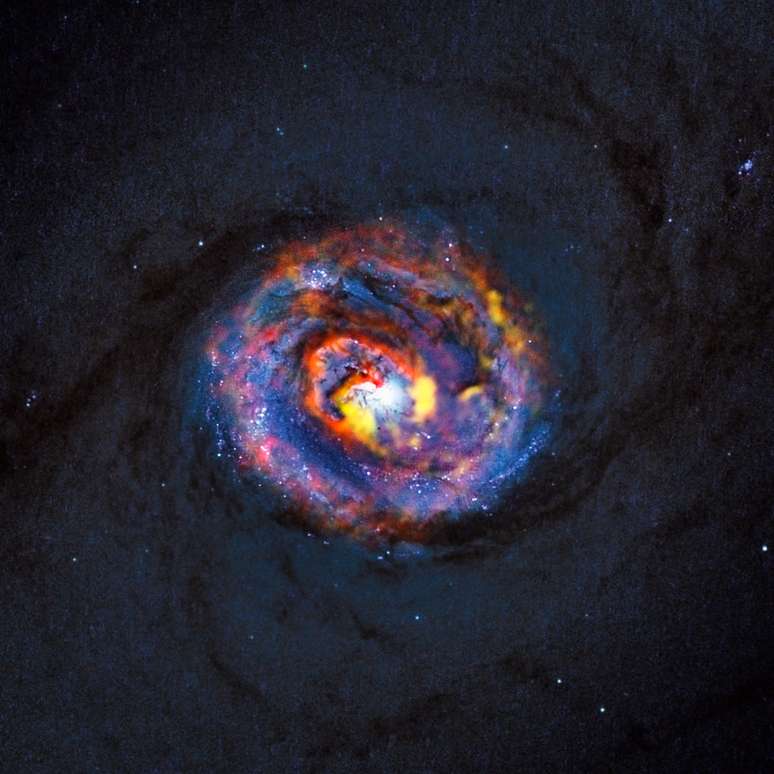 Observações revelaram pela primeira vez uma estrutura em espiral e uma inesperada corrente de material se deslocando para o exterior nas regiões centrais da galáxia ativa próxima NGC 1433
