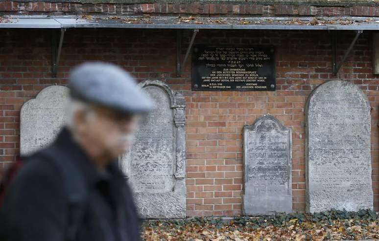 <p>Visitante passa em frente a&nbsp;v&aacute;rias l&aacute;pides no cemit&eacute;rio de Grosse Hamburger Strasse em&nbsp;Berlim</p>