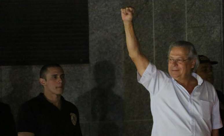 <p>Dirceu acena na chegada à sede da Polícia Federal, em São Paulo, após ter a sua prisão decretada</p>
