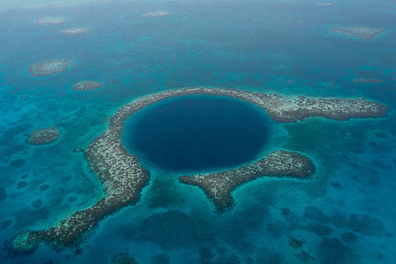 Belize - A Cidade de Belize já seria sozinha um belo cartão-postal, mas quem quiser se aventurar mais pode pegar um barco e avançar até o Blue Hole (Buraco Azul). Maior buraco azul do mundo, é um círculo perfeito com cerca de 2 quilômetros de largura e 145 metros de profundidade. Um espetáculo da natureza exuberante no Caribe