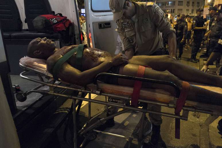 <p>Adilson Rufino dos Santos é levado para ambulância após ser baleado durante a noite de terça</p><p> </p>