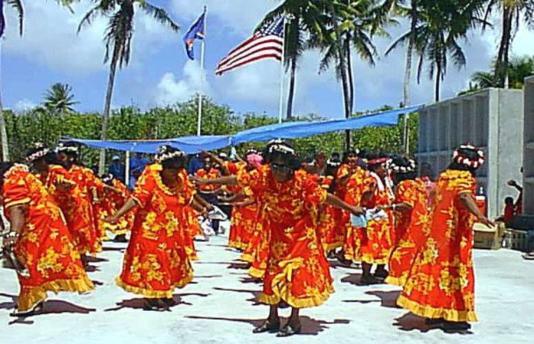 Habitantes da ilha de Rongelap dançam e cantam durante cerimônia em 1999, ano em que o trabalho de reabilitação teve início