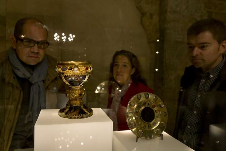 <p>Dois funcionários e um visitante observam o cálice que pertenceu à dona Urraca, filha do rei de Leon Fernando I, entre 1037 e 1065 - exposto no museu da Basílica de San Isidoro</p>