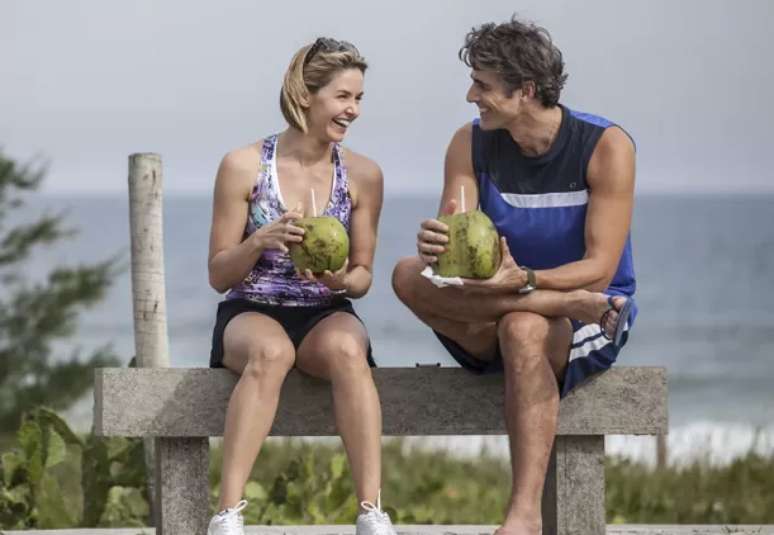 Cadu e Silvia conversam e caminha na orla da praia