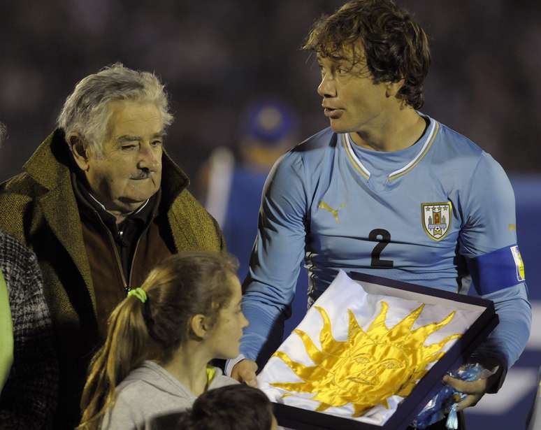 <p>Jos&eacute; Mujica, presidente uruguaio, cumprimentou jogadores antes do hino e entregou bandeira para Lugano trazer ao Brasil</p>