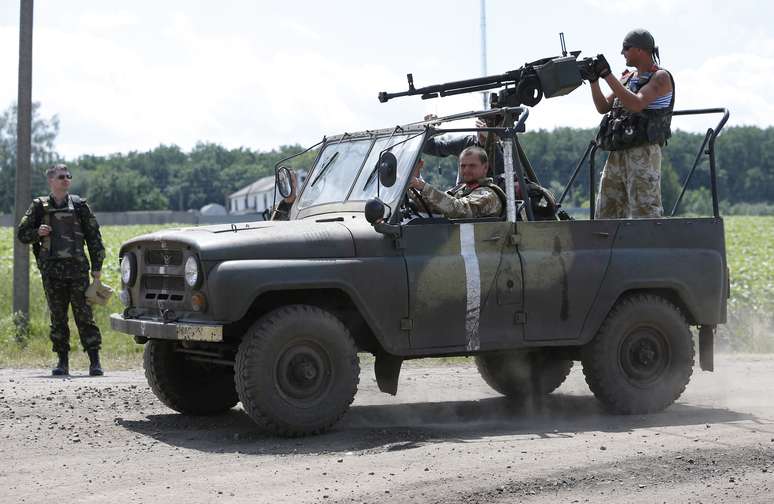 <p>Um grupo de soldados ucranianos avançam sobre uma aldeia de Dovgenke, na região de Donetsk, leste da Ucrânia, em 24 de junho</p>