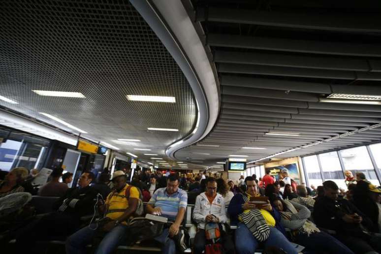 Passengers wait for their delayed flights at Alfonso Pena airport in Curitiba city, June 17, 2014. In a project called 'On The Sidelines' Reuters photographers share pictures showing their own quirky and creative view of the 2014 World Cup in Brazil.