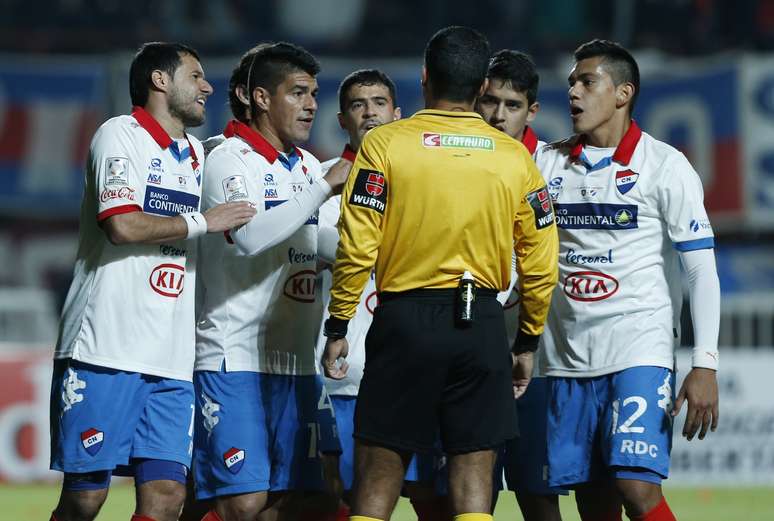 Jogadores do Nacional discutem com árbitro brasileiro Sandro Meira Ricci por marcação de pênalti