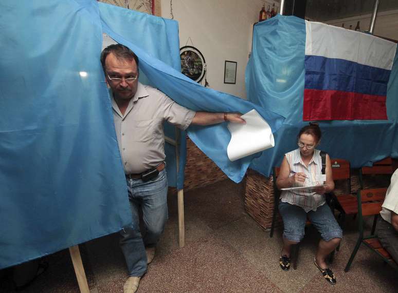 Um homem deixa a cabine de votação na assembleia de voto no porto de Sebastopol da Crimeia, neste domingo, 14 de setembro