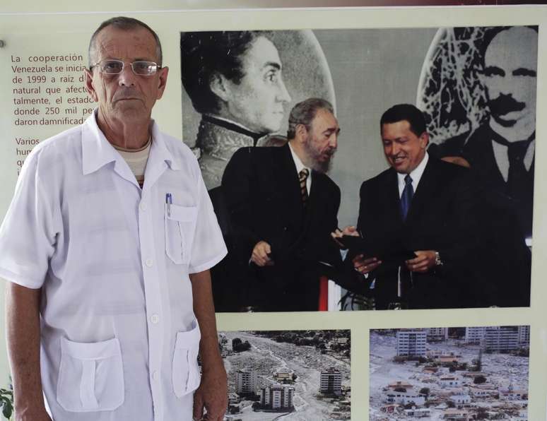 Um dos médicos cubanos tira foto ao lado de painel de líderes latinos