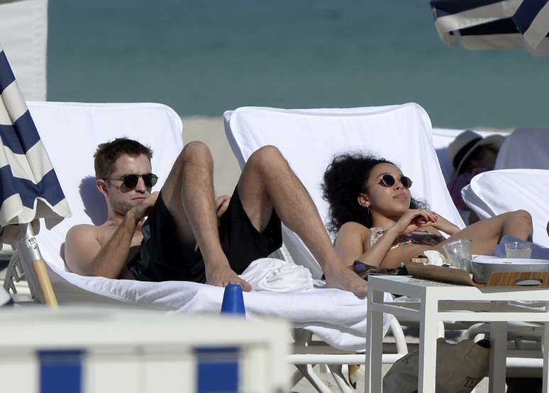 Robert Pattinson e a namorada, a cantora FKA, foram clicados enquanto curtiam um momento rom&acirc;ntico em uma praia de Miami (EUA)