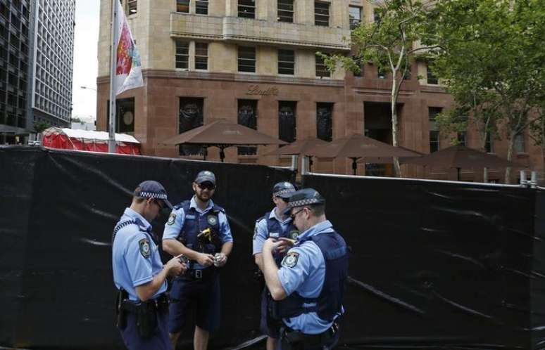 Policia autraliana monta guarda em frente a uma área isolada após ataque de um homem armado, em Sydney. 17/12/2014.