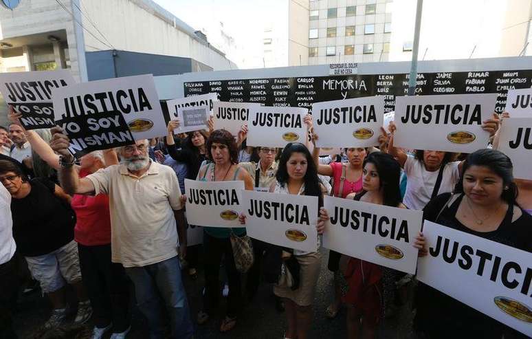 Argentinos exibem cartazes com a palavra "Justiça" em frente à associação judaica AMIA durante protesto para pedir justiça na morte de um promotor argentino envolvido na investigação de um atentado, em Buenos Aires. 21/01/2015