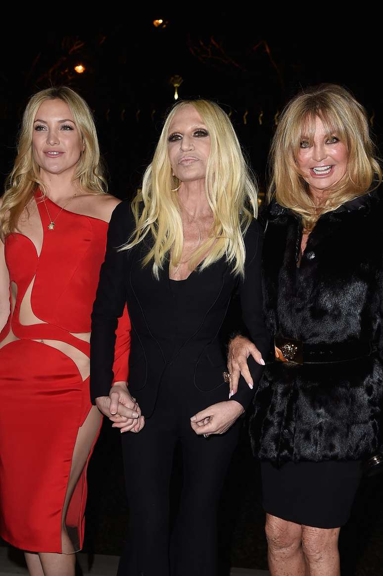 <p>A atriz Kate Hudson usou vestido mostrado da passarela e posou ao lado da m&atilde;e, a atriz Goldie Hawn, e da diretora da marca, Donatella Versace</p>