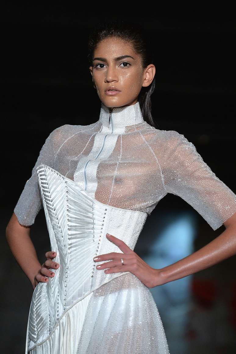 O corset de couro realça a cintura da modelo que usa camisa transparente por baixo