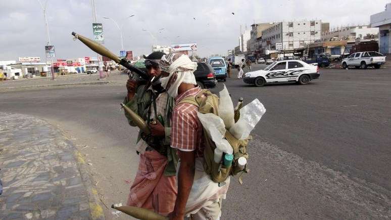 <p>Militantes patrulham rua que d&aacute; acesso ao aeroporto em &Aacute;den, no I&ecirc;men</p>