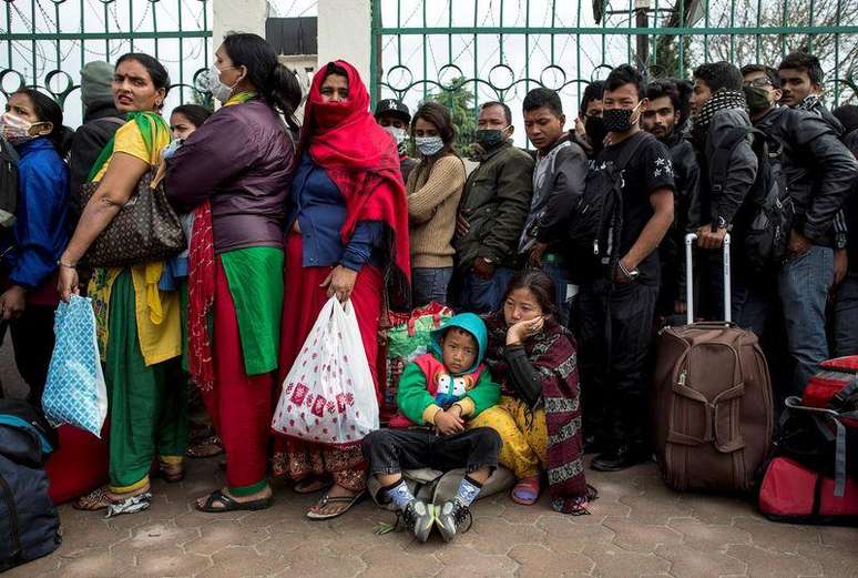 Pessoas esperando ônibus para deixar Katmandu, no Nepal