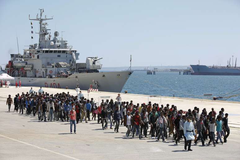 Imigrantes desembarcam do navio da Marinha italiana Vega, no porto siciliano de Augusta, sul da Itália