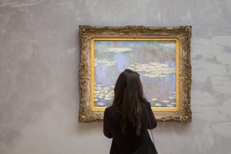 Mulher olhando quadro de Claude Monet, com valor entre 35 e 40 milhões de dólares, durante evento da Sotheby’s, em Manhattan.  01/05/2015