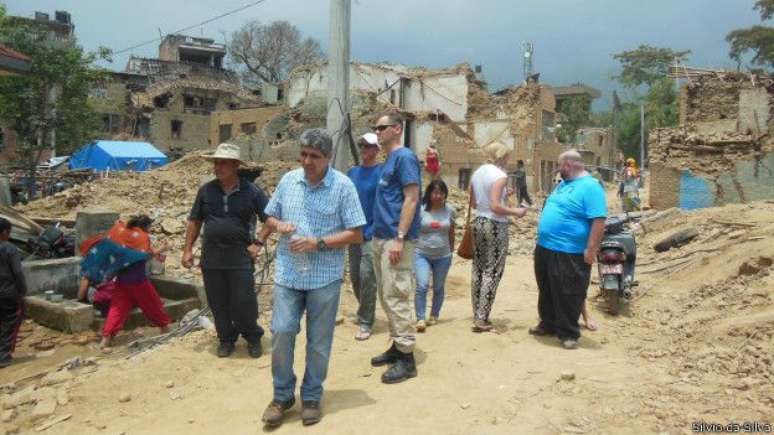 Sílvio Aparecido da Silva (de camisa quadriculada) caminha entre escombros do primeiro terremoto