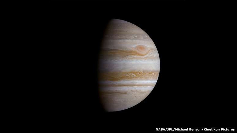 O Grande Ponto Vermelho de J&uacute;piter pode ser visto aqui. Trata-se de uma tempestade persistente que impede o avan&ccedil;o de nuvens brancas &agrave; sua direita. Com um tamanho tr&ecirc;s vezes superior ao da Terra, est&aacute; em curso h&aacute; pelo menos 348 anos.