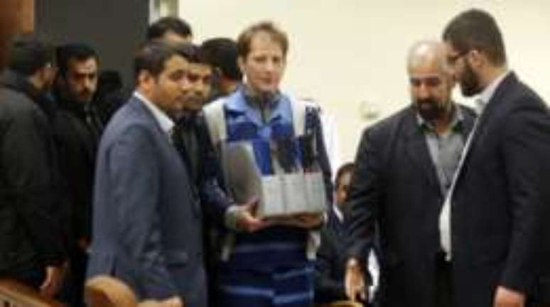 Na foto de novembro de 2015, Babak Zanjani chega a um tribunal em Teer&atilde; carregando uma s&eacute;rie de documentos