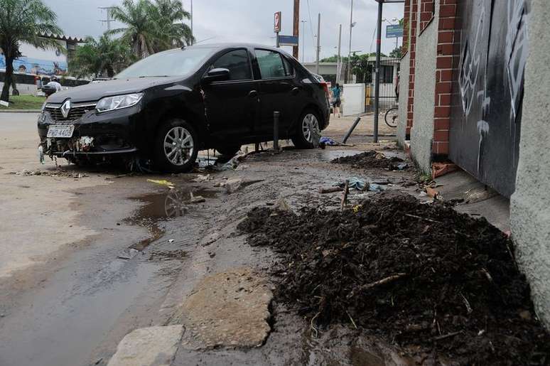 Carros empilhados pela correnteza de água na rua Jiquibá, na Praça da Bandeira, após o temporal na noite de sábado (12) que deixou a cidade em estágio de crise 