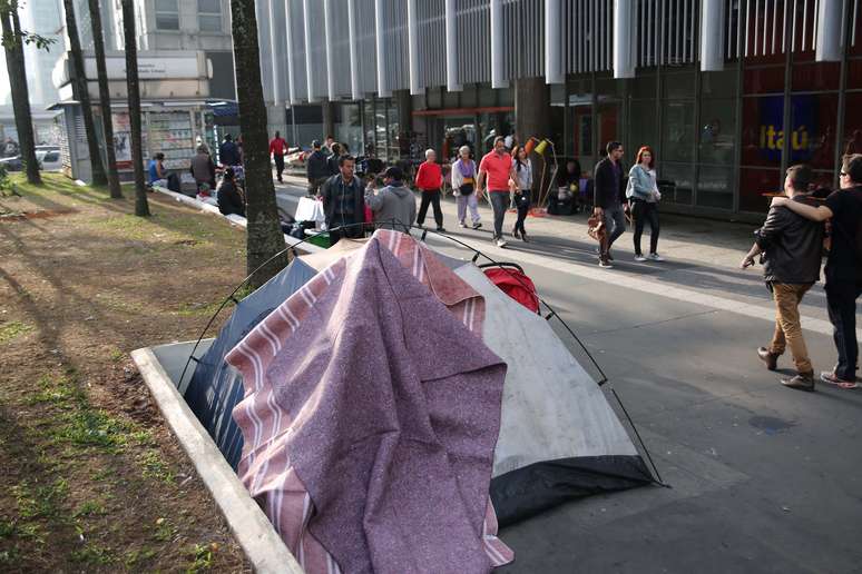 Morador de rua monta barraca em calçada da avenida Paulista.