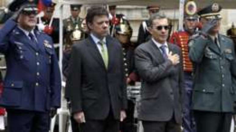 Santos (no centro) foi ministro da Defesa no governo de Alvaro Uribe (à direita)