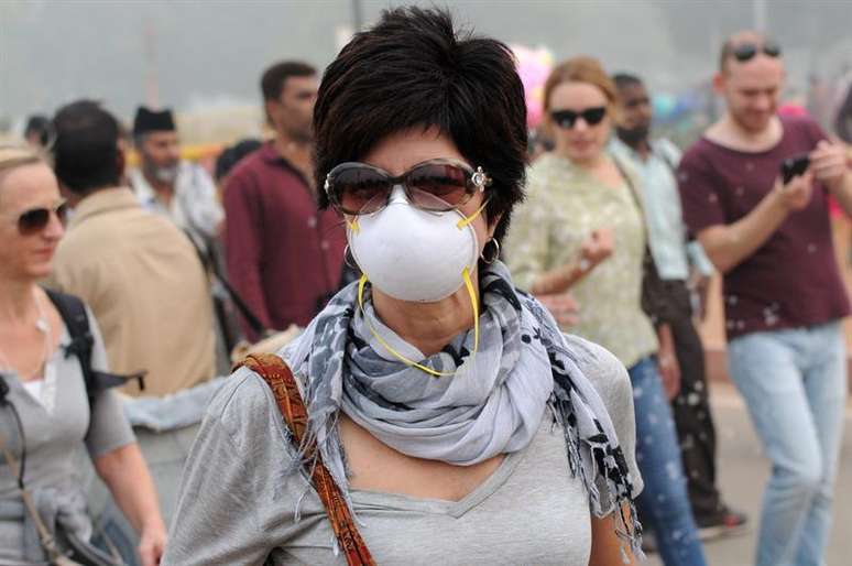 Estrangeira usando máscara em rua de Nova Délhi