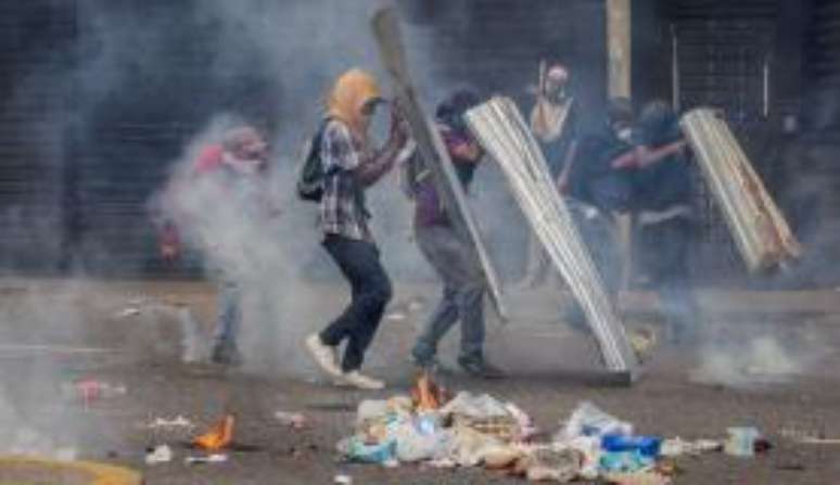 Manifestantes em Caracas, na Venezuela, entram em confronto com a Guarda Nacional do país