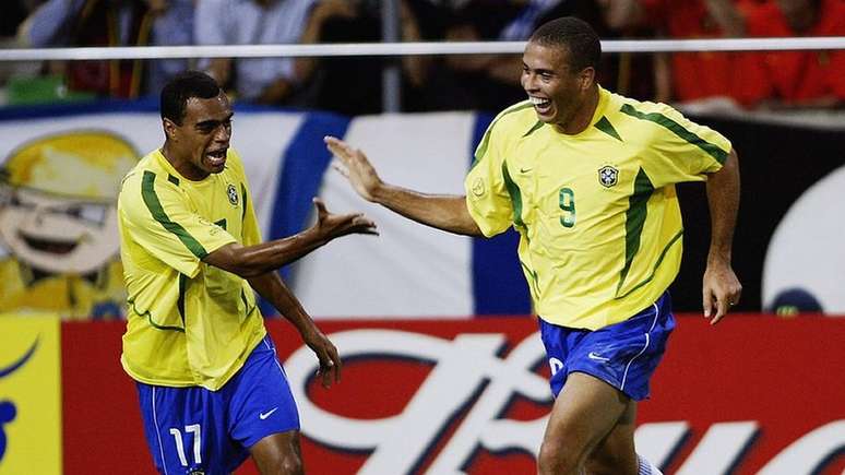 Den&iacute;lson (&agrave; esquerda) comemora com Ronaldo um gol na Copa do Mundo de 2002