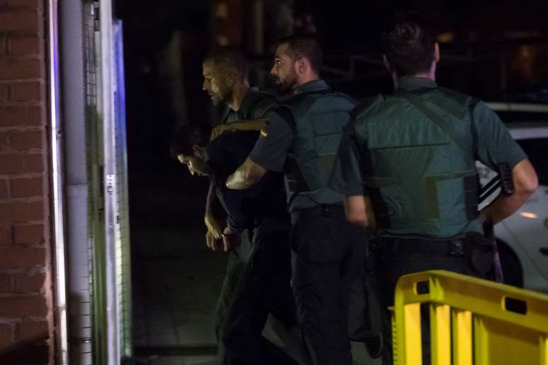 Forças de segurança acompanham um dos quatro detidos por relação com ataque de Barcelona, em Madri 21/08/2017 REUTERS/Juan Medina