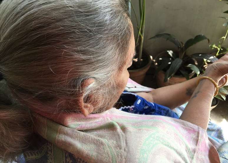 M&atilde;e olha para suas tatuagens