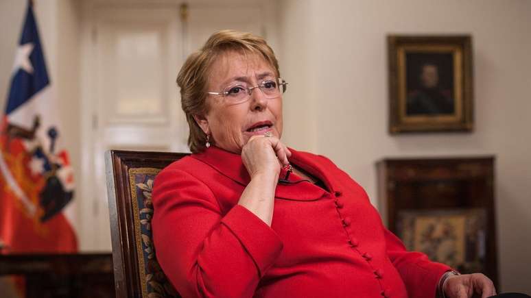 Michelle Bachelet dá entrevista sentada em cadeira no palácio de governo chileno