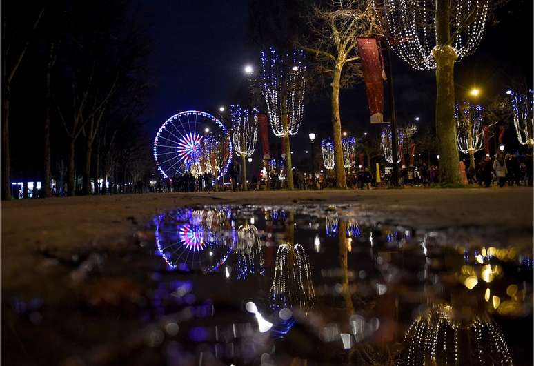 A água acumulada na calçada da praça da Concordia em Paris, reflete as luzes que enfeitaram o réveillon da capital francesa