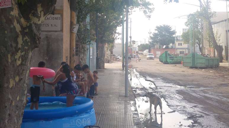 Crianças brincam em piscina de plástico na Villa 31: metade da população local é de imigrantes