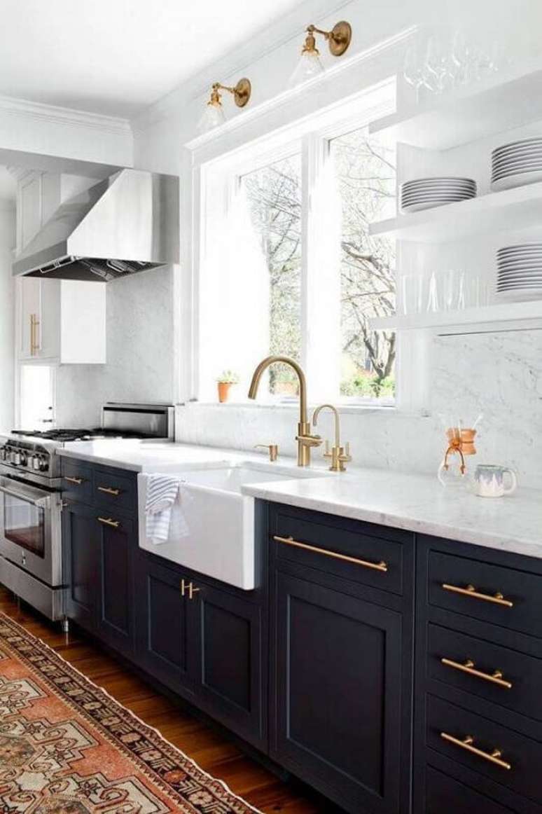 2. Decoração de cozinha requintada em tons de azul e branco com detalhes em dourado.