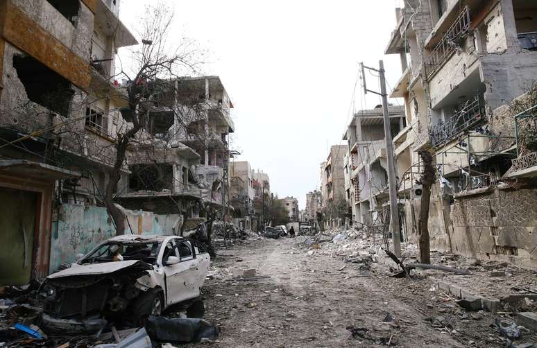 Prédios e carros danificados são vistos na cidade de Douma, em Ghouta Oriental, na Síria 25/02/2018 REUTERS/Bassam Khabieh