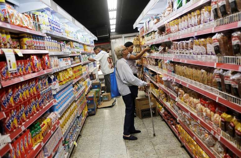 A customer looks at the prices at a supermarket in Rio de Janeiro, Brazil, May 6, 2016. REUTERS/Nacho Doce - S1BETCMMIOAA